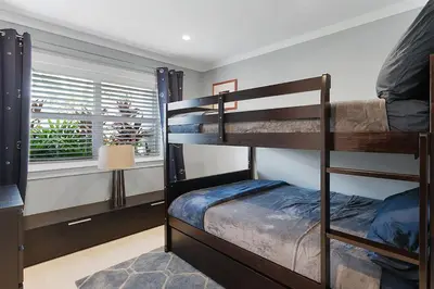 a bedroom with two bunk beds and a window at Infinity Luxury Waterfront Infinity Pool and Hot Tub SLEEPS 8 in Fort Lauderdale