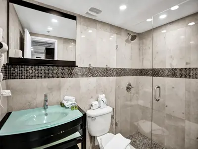 a bathroom with a toilet and a sink and a shower at Stylish Ocean Beach Retreat Beach Service 1009 in Miami Beach