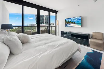 a bedroom with a large white bed with a large window at Oceanview Private Home at South Beach-814 in Miami Beach