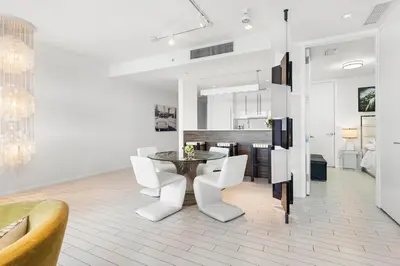 a dining room with a table and white chairs at Oceanview Private Home at South Beach-814 in Miami Beach