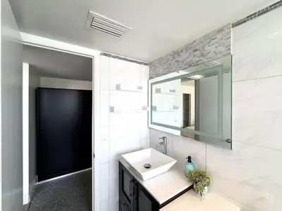 a bathroom with a sink and a mirror at The Octagon in South Beach in Miami Beach
