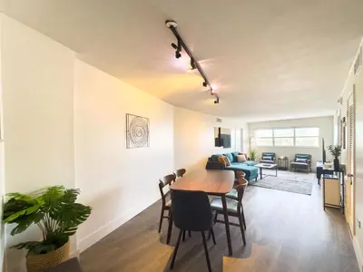 a dining room and living room with a table and chairs at The Octagon in South Beach in Miami Beach