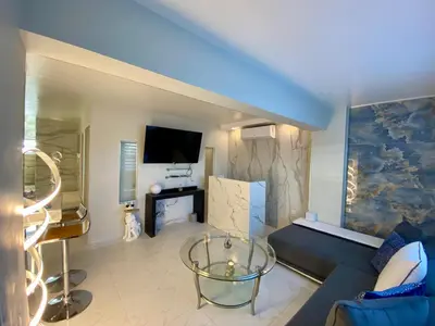 a living room with a couch and a tv at Luxurious remodeled direct Waterfront apartment with Miami skyline view- Free parking- 5min drive to Miami Beach in Miami Beach