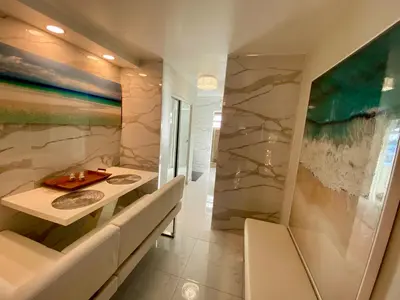 a bathroom with a stone wall and a table and chairs at Luxurious remodeled direct Waterfront apartment with Miami skyline view- Free parking- 5min drive to Miami Beach in Miami Beach