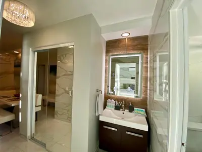 a bathroom with a sink and a shower at Luxurious remodeled direct Waterfront apartment with Miami skyline view- Free parking- 5min drive to Miami Beach in Miami Beach