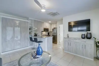a living room with a table with a blue vase at Waterfront Deck Pool Kayak in Fort Lauderdale