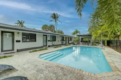 an image of a swimming pool in front of a house at Waterfront Deck Pool Kayak in Fort Lauderdale