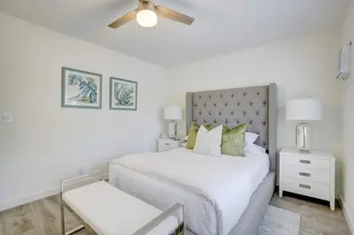 a white bedroom with a bed and a ceiling fan at Pool Access Free Parking Smart TV Wifi in Fort Lauderdale