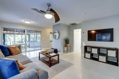 a living room with a couch and a tv at Waterfront Apartment Private Patio Pool in Fort Lauderdale