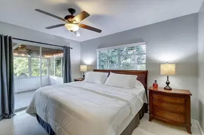 a bedroom with a bed and a ceiling fan at Waterfront Apartment Private Patio Pool in Fort Lauderdale