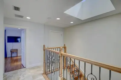 a staircase in a house with a ceiling at Private Patio Cali King Bed Walk to Las Olas in Fort Lauderdale