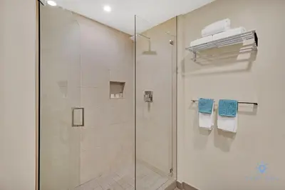 a bathroom with a shower with a glass door at Hollywood Beach Rooftop Pool Hot Tub in Hollywood