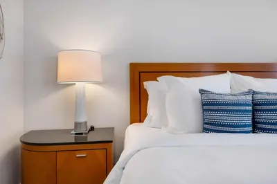 a bedroom with a bed with a lamp on a nightstand at 1435 Brickell Ave 3004 in Miami