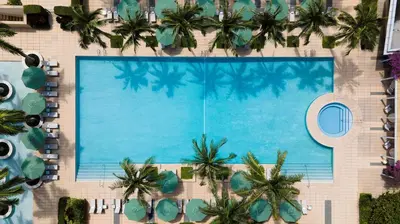 an overhead view of a swimming pool with palm trees at 1435 Brickell Ave 3004 in Miami