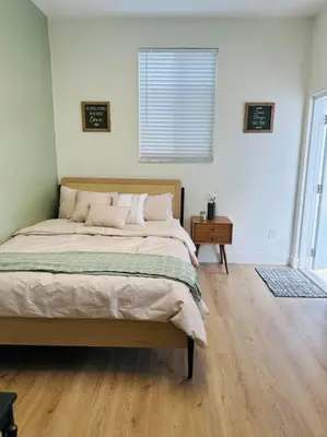 a bedroom with a bed and a wooden floor at Miami Coral Gables Studio near Airport and Beaches in Miami