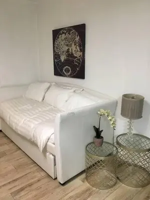 a white bed in a room with two tables at BEST DEAL! 2 Bedroom Modern Beachfront by YouRent! in Miami Beach