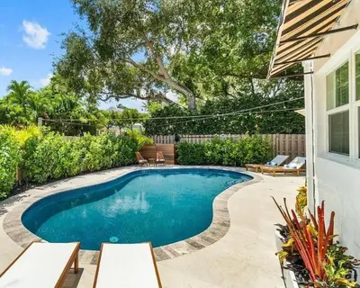 a swimming pool in the backyard of a house at Rio Vista Prestige on Las Olas Heated Pool in Fort Lauderdale
