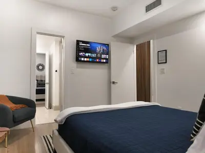 a bedroom with a bed and a tv on the wall at Rio Vista Prestige on Las Olas Heated Pool in Fort Lauderdale