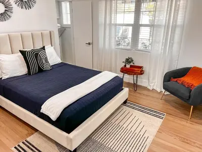 a bedroom with a large bed and a chair at Rio Vista Prestige on Las Olas Heated Pool in Fort Lauderdale