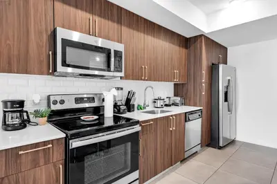 a kitchen with a stove and a microwave at Prime Location 1-Bed Retreat With Free Parking in Miami