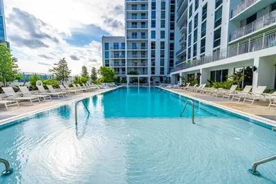 a large swimming pool with chairs in a building at Prime Location 1-Bed Retreat With Free Parking in Miami