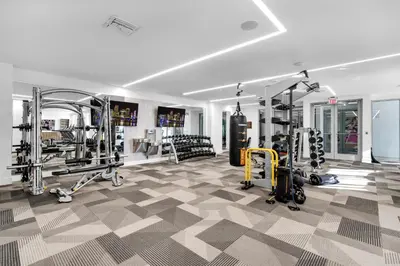 a gym with several treadmills and weights at Prime Location 1-Bed Retreat With Free Parking in Miami