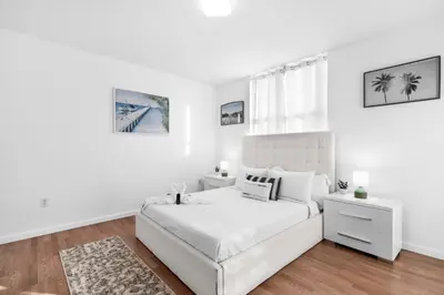 a white bedroom with a white bed and white walls at Spacious 2 Bed Unit in Brickell with Free Parking in Miami