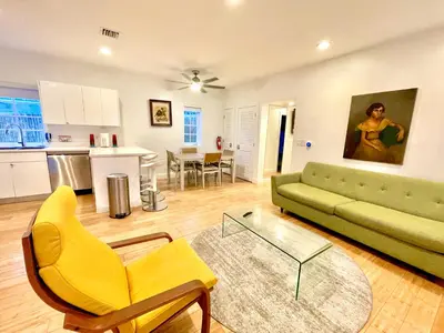 a living room with a green couch and a table at 20 GUESTS LUXURIOUS SOUTH BEACH SUITE 2 in Miami Beach