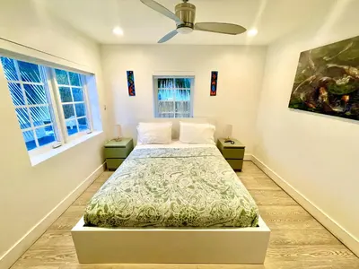 a bedroom with a bed and two windows at 60 Guests Luxury South Beach Private Estate in Miami Beach