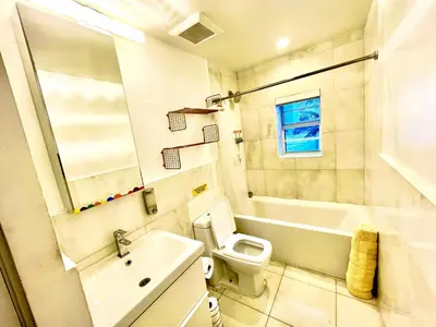a bathroom with a toilet and a tub and a sink at 60 Guests Luxury South Beach Private Estate in Miami Beach