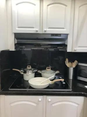 a stove top with three pots and pans on it at Special $$$! 2 Bedroom Oceanfront Condo in Hollywood/Hallandale Beach! in Hollywood