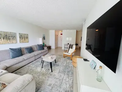 a living room with a couch and a tv at Special $$$! 2 Bedroom Oceanfront Condo in Hollywood/Hallandale Beach! in Hollywood