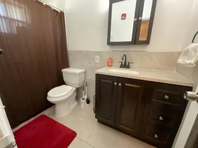 a bathroom with a toilet and a sink and a mirror at Private Studio Near Guitar Casino & Stadium in Carver Ranches