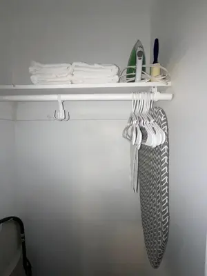 a rack with utensils on a shelf in a closet at Private Studio Near Guitar Casino & Stadium in Carver Ranches