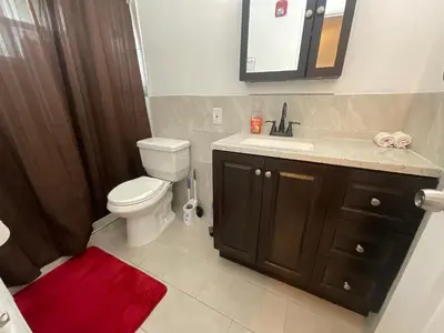 a bathroom with a toilet and a sink and a mirror at Private Studio Near Guitar Casino & Stadium in Carver Ranches