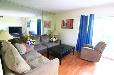 a living room with a couch and a table at Sunny Isles Apartments by MiaRentals in Sunny Isles Beach