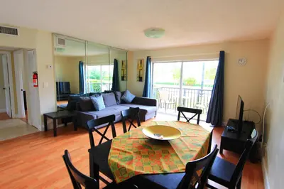 a living room with a table and a couch at Sunny Isles Apartments by MiaRentals in Sunny Isles Beach