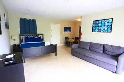 a living room with a couch and a bed at Sunny Isles Apartments by MiaRentals in Sunny Isles Beach