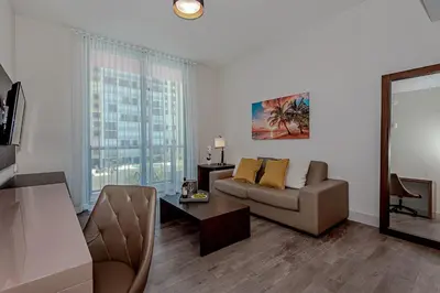 a living room with a couch and a table at Hollywood Beach Rooftop Pool Balcony in Hollywood