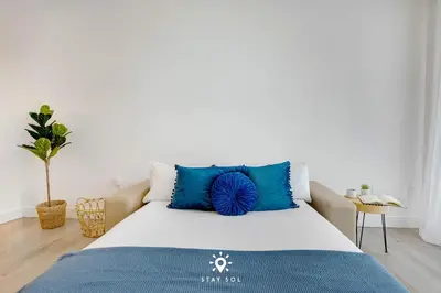 a bedroom with a large bed with blue pillows at Hollywood Beach Rooftop Pool Balcony in Hollywood
