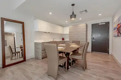 a dining room and kitchen with a table and chairs at Hollywood Beach Rooftop Pool Balcony in Hollywood