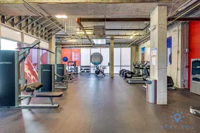 a gym with several treadmills and cardio machines at Hollywood Beach Rooftop Pool Balcony in Hollywood