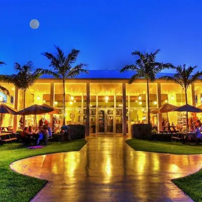 a building with palm trees in front of it at night at Free BBQ in RV With Private entrance in Homestead