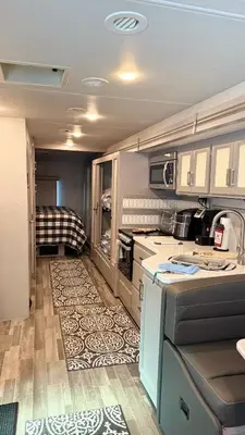 an rv with a kitchen and a living room at Private Cozy R/V , for your enjoyment in Tamiami