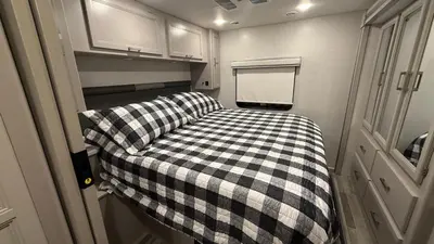 a small room with a checkered bed in an rv at Private Cozy R/V , for your enjoyment in Tamiami