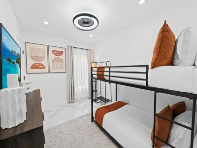 a bedroom with two bunk beds in a room at Spacious home w heated pool jacuzzi in Hollywood