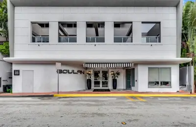 a white building with a sign on the front of it at Hotel Miami Beach Convention Center in Miami Beach