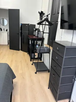 a bedroom with a desk and a dresser with a dresserngth at Sri House in Miami
