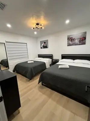 a bedroom with two beds and a ceiling at Sri House in Miami