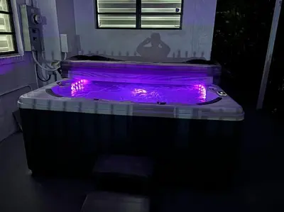 a hot tub with purple lights in the dark at Sri House in Miami